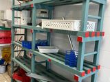 a shelf with baskets and containers on it in a kitchen