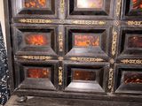 an old wooden cabinet with many drawers on it