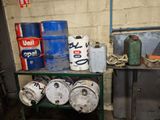 many kegs sitting on a shelf in a room