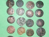 a lot of coins that are on a green surface
