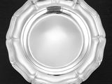a silver plate that is on a black table