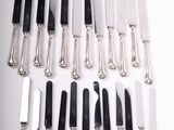 a lot of knives that are sitting on a table