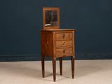 an old wooden dresser with a mirror on top of it