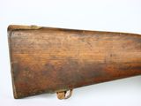 an old wooden rifle with a wooden barrel on a white background