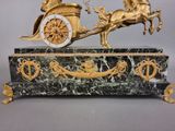 a statue of a horse pulling a carriage with a man on it
