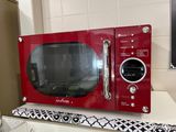 a red microwave sitting on top of a white counter