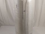 a large roll of white yarn wrapped in plastic on top of a white table