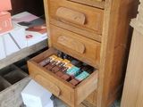 a desk with a drawer full of books and toys