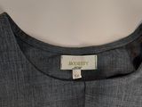 a close up of a grey shirt with a label on it