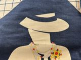 a blue shirt with a picture of a man with a hat on it