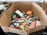 a cardboard box filled with assorted items on the floor