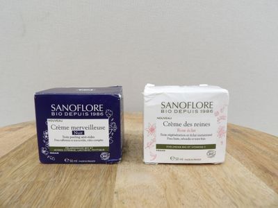 two boxes of soap sitting on a wooden table