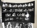 a black and white photo of a wall with pictures of people on it