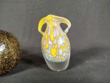 two glass vases sitting next to each other on a table