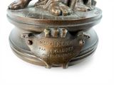 a bronze statue of a dog on a pedestal