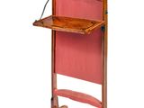 a wooden podium with a red chair and a laptop on it