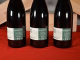 three bottles of wine sitting next to each other on a table