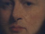a blurry image of a woman ' s face in a mirror