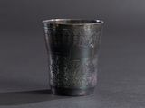 a silver cup that is sitting on a table
