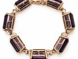 an amethorate bracelet with gold and purple stones