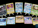 a lot of pokemon cards that are on the table