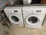 two washers sitting next to each other in a kitchen