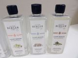 three bottles of perfume are lined up on a white table