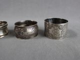 three silver napkin rings sitting next to each other on top of a table