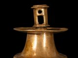 an old brass bell on a black background with a black background