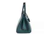 a green crocodile skin handbag on a white background