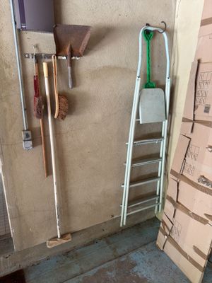 une pile de cartons et une échelle dans un coin de la pièce