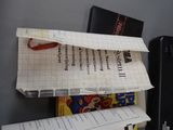 a paper airplane sitting on top of a pile of books