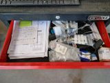 a red box with a keyboard and a lot of items in it