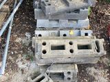 a pile of cinder blocks sitting on the ground next to a fence