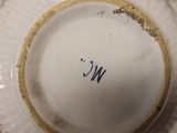 a white plate with a gold rim and a black writing on it