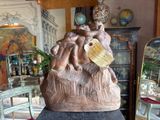 a statue of a man holding a child on a table
