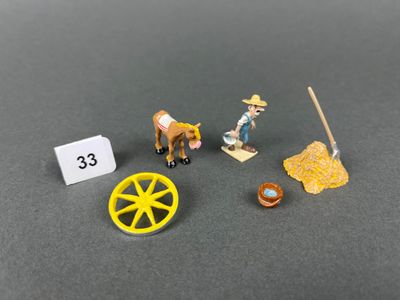 une figurine représentant un homme avec un cheval et une charrette