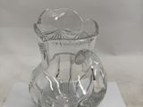 a clear glass vase on a white surface