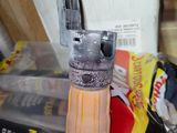an image of a close up of a lighter on a table
