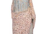 a statue of a woman holding a blanket on a white background