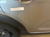 a car with a sticker on the side of it ' s door