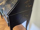 a black table with a black top and a gold design on it