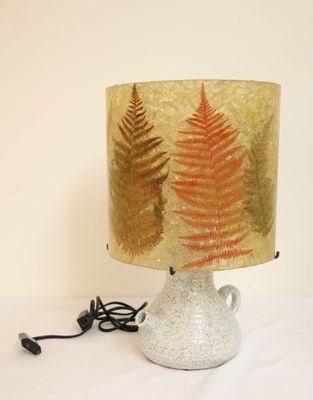 a lamp that is sitting on a table with a lamp shade on it