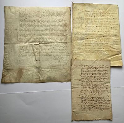two pieces of paper with writing on them sitting on a table