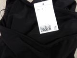 a close up of a black pants with a price tag on it