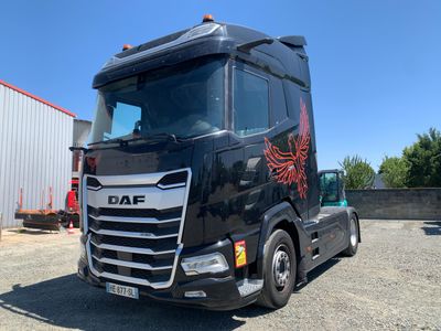 a large black truck parked in a parking lot