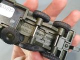 a person holding a small toy train in their hand