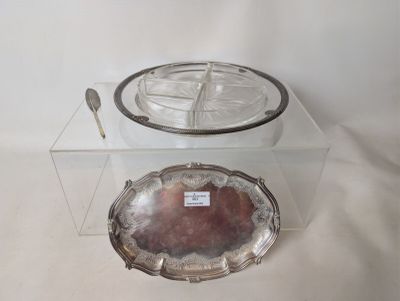 a silver plate with a spoon on it and a silver plate with a spoon on it