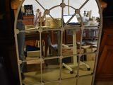 a mirror that is sitting on the floor in a room