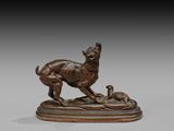 a bronze statue of a dog and a cat on a base
